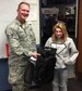 Staff Sgt. Victor Blazevic, 339th Recruiting Squadron enlisted accessions recruiter, presents an Air Force backpack to Megan Darby, a student at Porter County Career Center in Valporaiso, Ind., Nov. 9. Darby won the backpack in a drawing after Blazevic spoke to her automotive technology class about the opportunities and benefits of joining the Air Force.