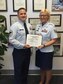 Senior Master Sgt. Brian Dixon, 331st Recruiting Squadron production superintendent, presents Staff Sgt. Angela Williams, 331st RCS enlisted accessions recruiter, with her recruiter certification, Oct. 17.