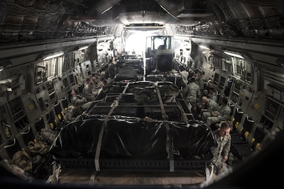 More than 30 members of the Air Force’s 621st Contingency Response Wing wait aboard a C-17 Globemaster III at Joint Base McGuire-Dix-Lakehurst, N.J., for equipment to be loaded on their way to Port-au-Prince, Haiti, in response to Hurricane Matthew, Oct. 6, 2016. The CRW is supporting the government of Haiti's request for humanitarian assistance and will facilitate the movement of humanitarian aid and cargo. Air Force photo by Airman 1st Class Zachary Martyn