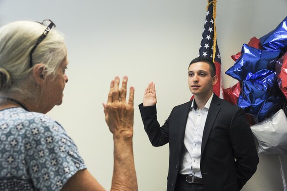 Airman Aris D. Soltani, a 940th Aircraft Maintenance Squadron personnelist, recites the Oath of Allegiance Oct. 11, 2016, in Sacramento, California. Soltani was born in Germany and had been working toward citizenship for almost six years. (U.S. Air Force Photo by Senior Airman Tara R. Abrahams)