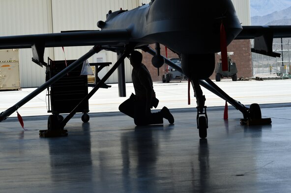 A 432nd Aircraft Maintenance Squadron, Tiger Aircraft Maintenance Unit maintainer inspects an MQ-1 Predator Aug. 24, 2016, at Creech Air Force Base, Nevada. Tiger Aircraft Maintenance Unit has started the transition to the larger, more capable MQ-9 Reaper.  (U.S. Air force photo by Airman 1st Class James Thompson)