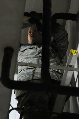 Staff Sgt. Corey Reining, 386th Expeditionary Civil Engineer Squadron heating, ventilation, and air conditioning technician, works on a unit inside the rations warehouse Sep. 2, 2016, at an undisclosed location in Southwest Asia. Due to extremely high temperatures, the 386 ECES HVAC shop must maintain the A/C units across the base more frequently to keep them at their optimal performance levels. (U.S. Air Force photo/Senior Airman Zachary Kee)