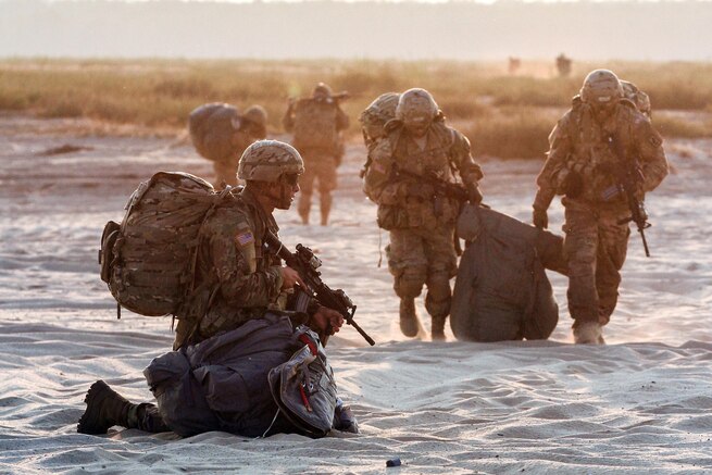 Paratroopers prepare to move from a drop zone after an airborne insertion exercise to support Operation Atlantic Resolve in Chechło, Poland, Sept. 12, 2016. Army photo by Sgt. Lauren Harrah