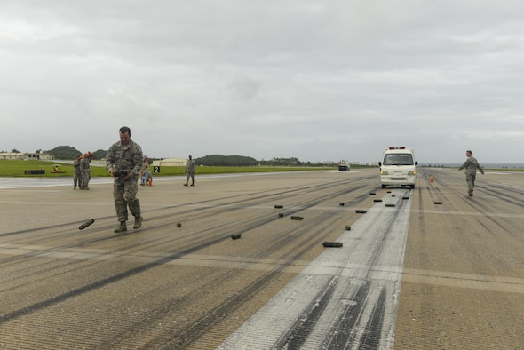 Members of the 18th Civil Engineer Squadron simulate the Kadena Air Base, Japan, runway being hit with munitions during exercise Resilient Shogun Sept. 15, 2016. The 18th Civil Engineer Squadron was one of the units in the Air Force to receive training on a new airfield damage repair capability (U.S. Air Force photo by Senior Airman Stephen G. Eigel)