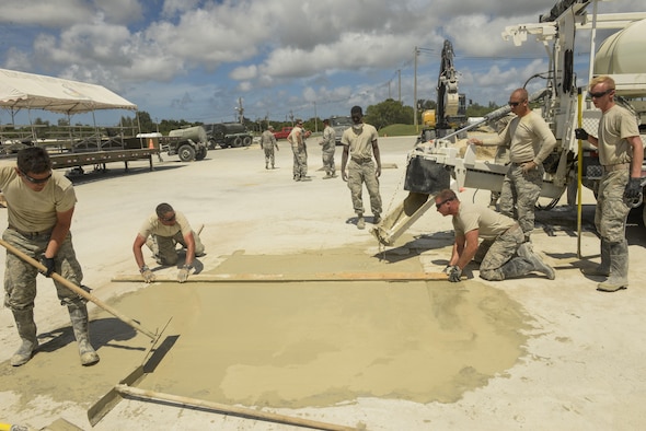U.S. Airmen assigned to the Kadena, Yokota and Misawa civil engineer squadrons practice concrete screeding skills using the materials, equipment and methods to repair craters during airfield damage repair training exercise at Kadena Air Base, Japan, Sept, 15, 2016. This process can be done quickly in combat situations so airfield operations can resume. (U.S. Air Force photo by Senior Airman Stephen G. Eigel)