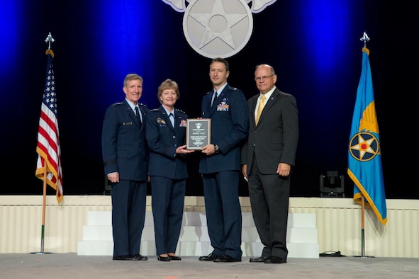 Lt. Col. Michael Bess (centered right), 84th Test and Evaluation Squadron, receives his Air Force Association President's Award on Sept. 19. (courtesy photo)