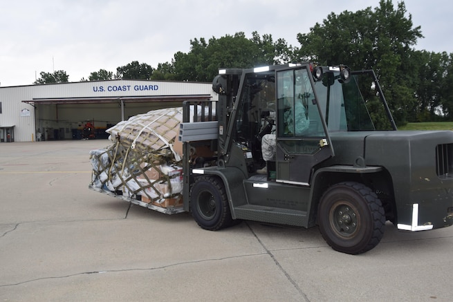 Tech Sgt. Ken Williams transports a palletized load of U.S. Coast Guard assets here on Tuesday. U. S. Coast Guard Air Station Detroit deployed 25 search and rescue crew members to Ellington Field Joint Reserve Base, Houston, to aid in relief efforts in the wake of Hurricane Harvey.