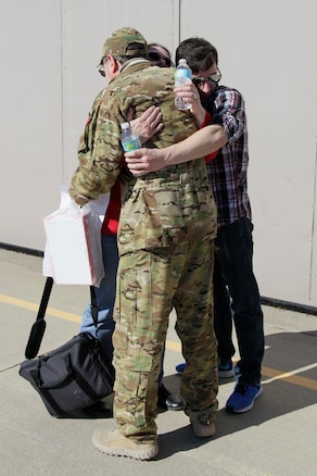 170219-Z-NQ307-160 -- An Airman from the 127th Air Refueling Group hugs his family upon his return to Selfridge Air National Guard Base, Mich. Approximately 85 Airmen and three aircraft from the Michigan Air National Guard's 127th ARG returned from a 60 day deployment to the Central Command area of responsibility on February 19th, 2017. (U.S. Air National Guard photo by TSgt. Rachel Barton)