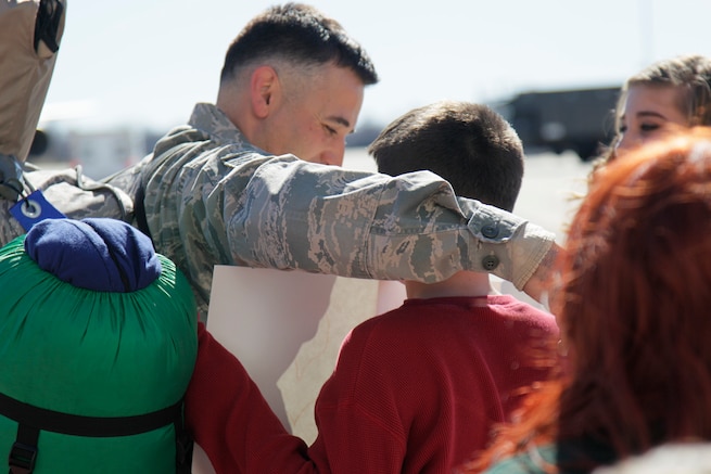 170219-Z-NQ307-105 -- A Michigan Air National Guard Airman from the 127th Air Refueling Group greets his son on the Airfield at Selfridge Air National Guard Base, Mich. upon returning from a deployment on February 19th, 2017. Approximately 85 Airmen and 3 aircraft from the 127th ARG returned from a 60 day deployment to Central Command. (U.S. Air National Guard photo by TSgt. Rachel Barton))