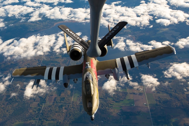 An A-10 with the 107th Fighter Squadron, flies with a KC-135 Stratotanker with the 171st Air Refueling Squadron over Northern Michigan on Oct. 11, 2017.