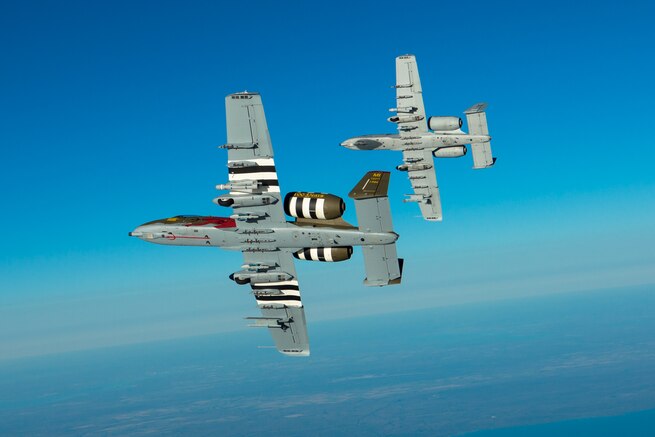 An A-10 with the 107th Fighter Squadron, flies with a KC-135 Stratotanker with the 171st Air Refueling Squadron over Northern Michigan on Oct. 11, 2017.