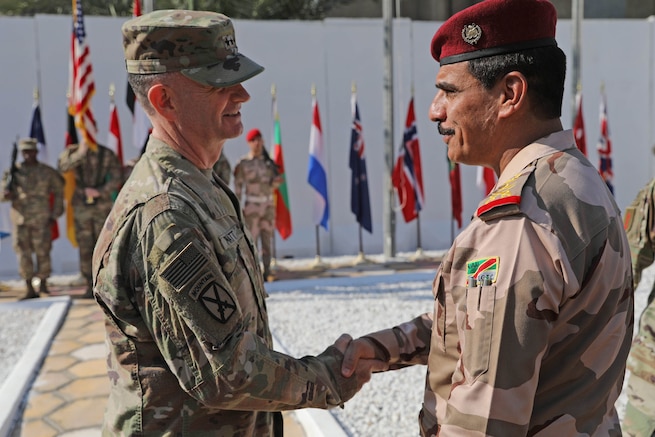 Maj. Gen. Walter Piatt, commander of Combined Joint Forces Land Component Command, shakes hands with Iraqi staff Lt. Gen. Abdul Amir al-Lami, deputy commander of Iraq Joint Operations Command, during the CJFLCC deactivation ceremony in Baghdad, Iraq, April 30, 2018. The deactivation signifies the end of major combat operations against ISIS in Iraq and acknowledges the changing composition and responsibilities of the Coalition.  (U.S. Army photo by Master Sgt. Horace Murray)