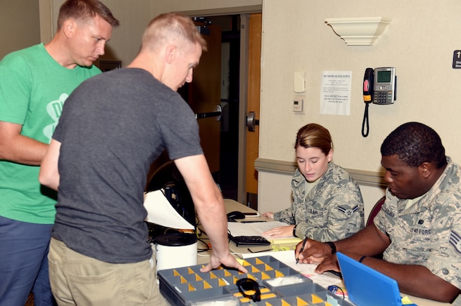 Airman 1st Class Julia McEachin, lodging apprentice, and Staff Sgt. Emuobosan Ojaruega, nightshift lodging non-commissioned officer in charge, both of the 127th Force Support Squadron, Selfridge Air National Guard Base, Mich., provide room assignments at the Alpena Combat Readiness Training center on August 5, 2018. Tech.