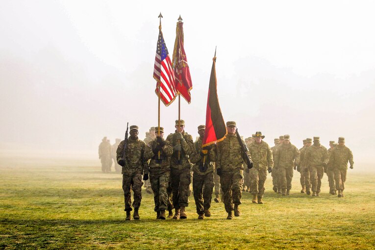 Soldiers march on a field.
