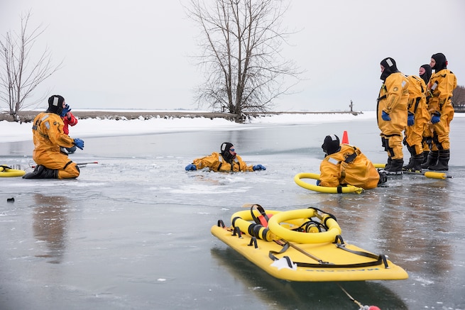 Phill Ulmer, chief of public affairs, 127th Wing here, practices self-rescue techniques during an ice rescue training exercise on Lake St. Clair, Harrison Township, Mich. on Jan. 31,