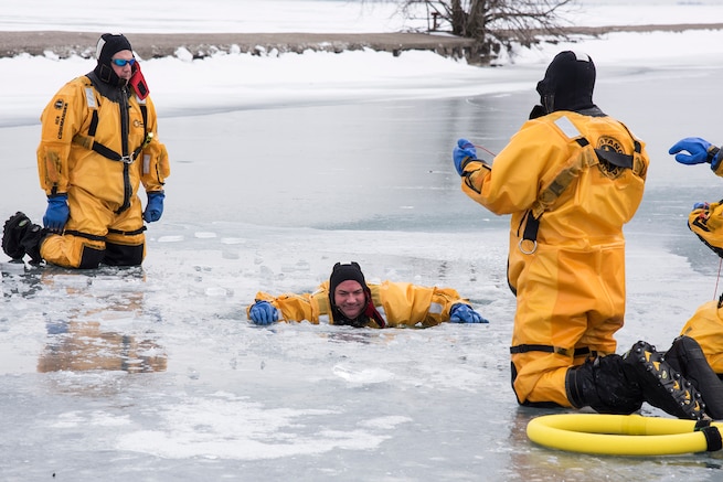Dave Long and Joe Zydel, firefighters with the 127th Civil Engineer Squadron, assigned to the Selfridge Air National Guard Base fire department, practice self-rescue techniques during an ice rescue training exercise on Lake St. Clair, Harrison Township, Mich. on Jan. 31, 2017.