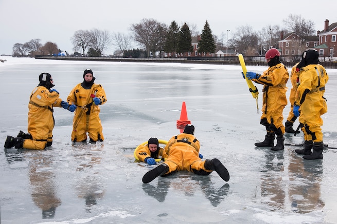 Firefighters of the 127th Civil Engineering Squadron, assigned to the Selfridge Air National Guard Base fire department, practice victim-extraction during an ice rescue training exercise on Lake St. Clair, Harrison Township, Mich. on Jan. 31, 2017.