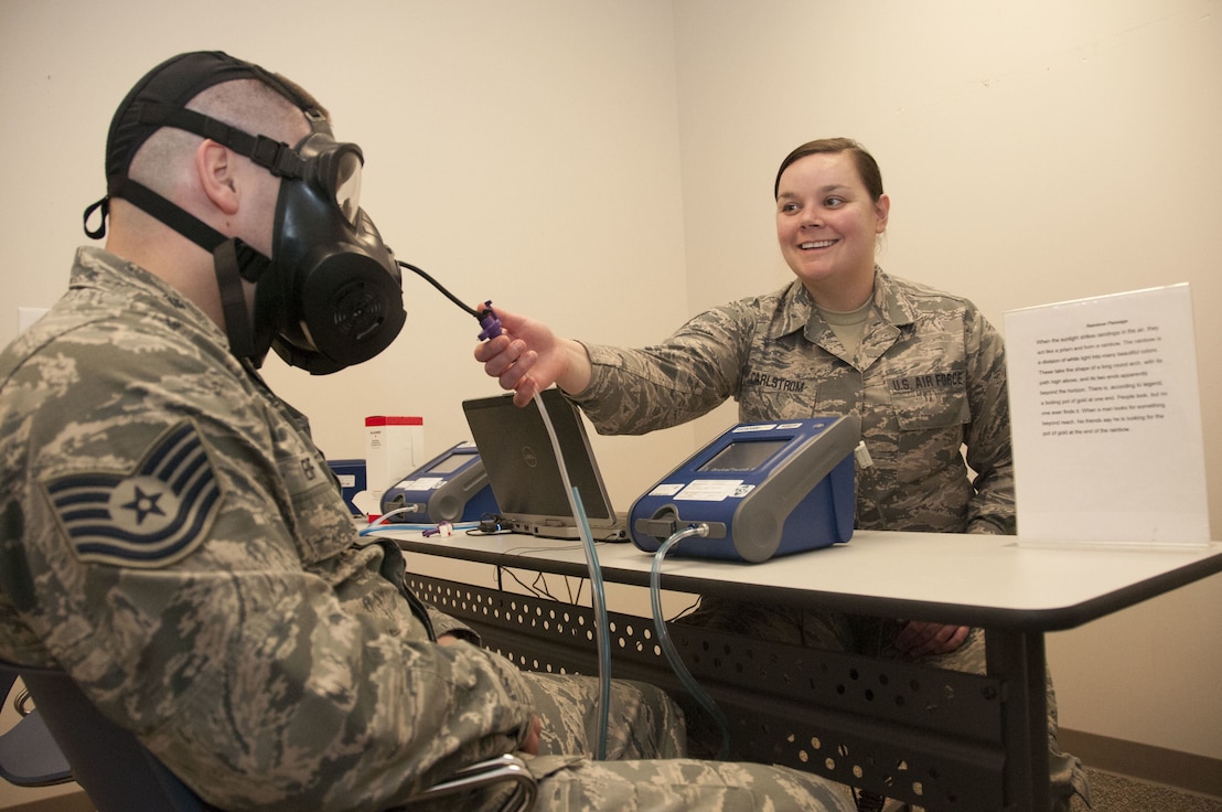 Staff Sgt. Audrey Carlstrom a bio-environmental engineering technician with the 127th Medical Group, practices administering a fit test on Tech. Sgt. Brandon Reif, a fellow bio-environmental engineering technician, while waiting for the next customer on February 3, 2018.  Quantitative fit tests are conducted on gas masks to ensure the mask properly fits all servicemembers assigned to wear them.