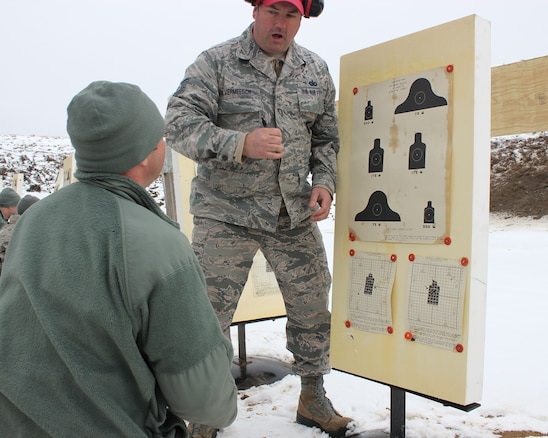 Tech. Sgt. Brad Vermeesch, a combat arms training instructor, reviews the marksmanship of a fellow Airman during training at Selfridge Air National Guard Base, Mich., Feb. 4, 2018. The Citizen-Airmen of the 127th Wing spent the February regularly scheduled drill focused on expeditionary skills training.