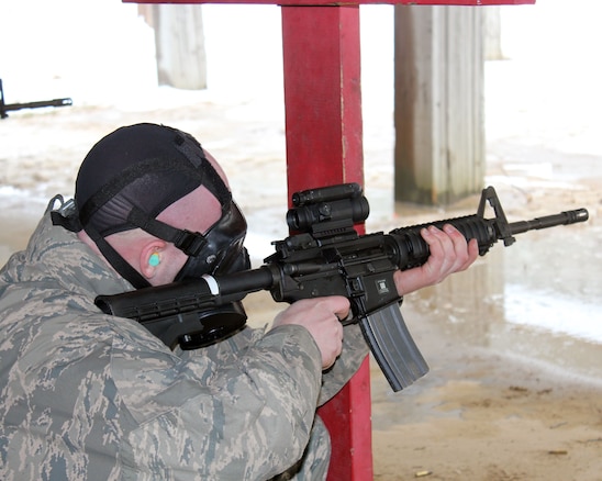 Senior Airman Scott Lange fires an M-4 rifle during marksmanship training, while wearing a gas mask, at Selfridge Air National Guard Base, Mich., Feb. 4, 2018. The Citizen-Airmen of the 127th Wing spent the February regularly scheduled drill focused on expeditionary skills training.