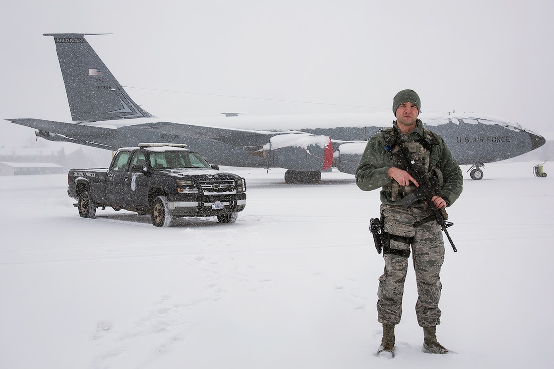 Senior Airman Robert Wodowski, defender with the 127th Security Forces Squadron here, secures a KC-135 Stratotanker on the flight line today, This weekend, Woodowski and other personnel of the 127th Wing will continue to endure harsh weather conditions as a significant winter storm commences upon the metropolitan Detroit region. Local weather reports estimate snowfall to accumulate up-to one-foot and sub-freezing temperatures for the next few days. Selfridge Air National Guard Base personnel remain ready for any prescribed contingency and a blizzard during Michigan's winter season provides an opportunity to practice resiliency and readiness while dealing with a well-known, yet hard-to-predict adversary: Mother Nature.