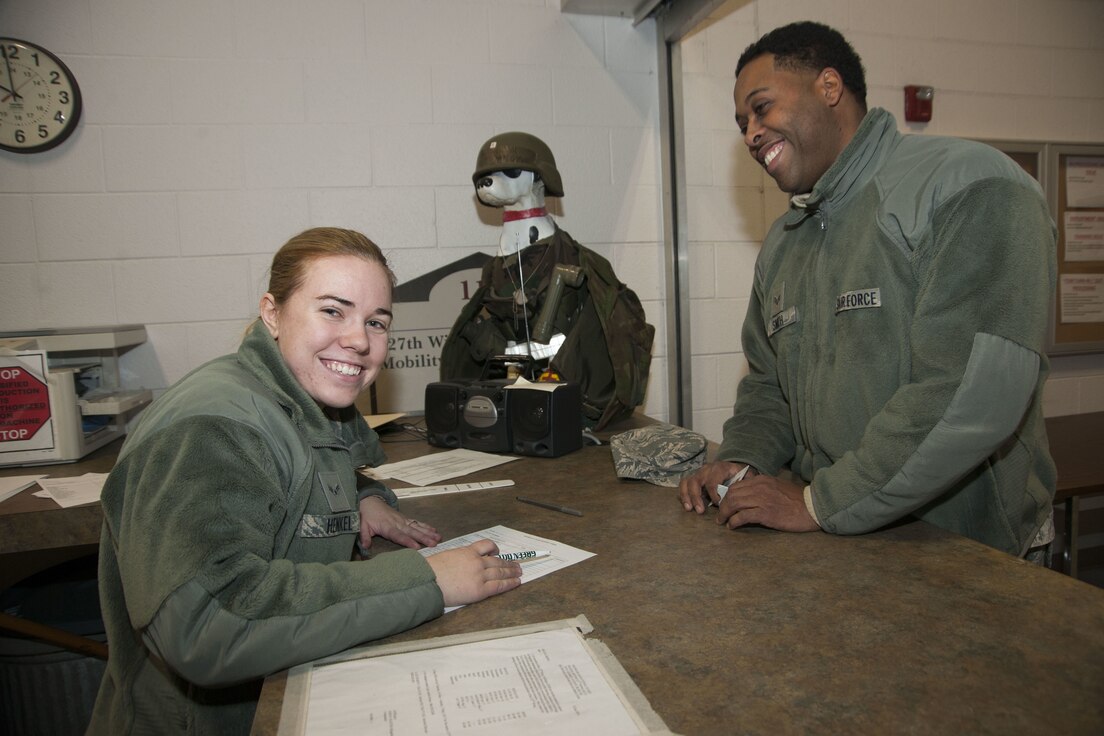 Airman 1st Class Melissa Alotta, 191st Maintenance Squadron, tries on a helmet while receiving her protective chemical warfare gear at Selfridge Air National Guard Base, Mich., Jan. 6, 2018. Issuing the equipment is Airman 1st Class Sarah Henkel, 127th Logistics Readiness Squadron