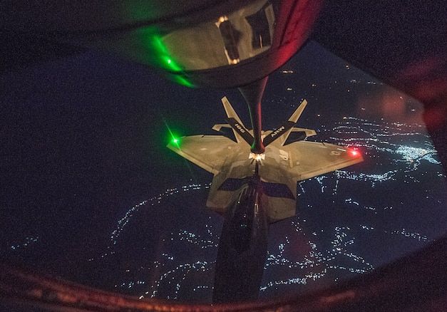 A U.S. Air Force F-22 Raptor receives in-flight fuel from a KC-135 Stratotanker assigned to the 28th Expeditionary Air Refueling Squadron during an aerial refueling mission in support of Operation Inherent Resolve over Iraq, July 6, 2018. The F-22 is designed to project air dominance, rapidly and at great distances and defeat threats attempting to deny access to our nation's Air Force, Army, Navy and Marine Corps. (U.S. Air Force photo by Staff Sgt. Keith James)