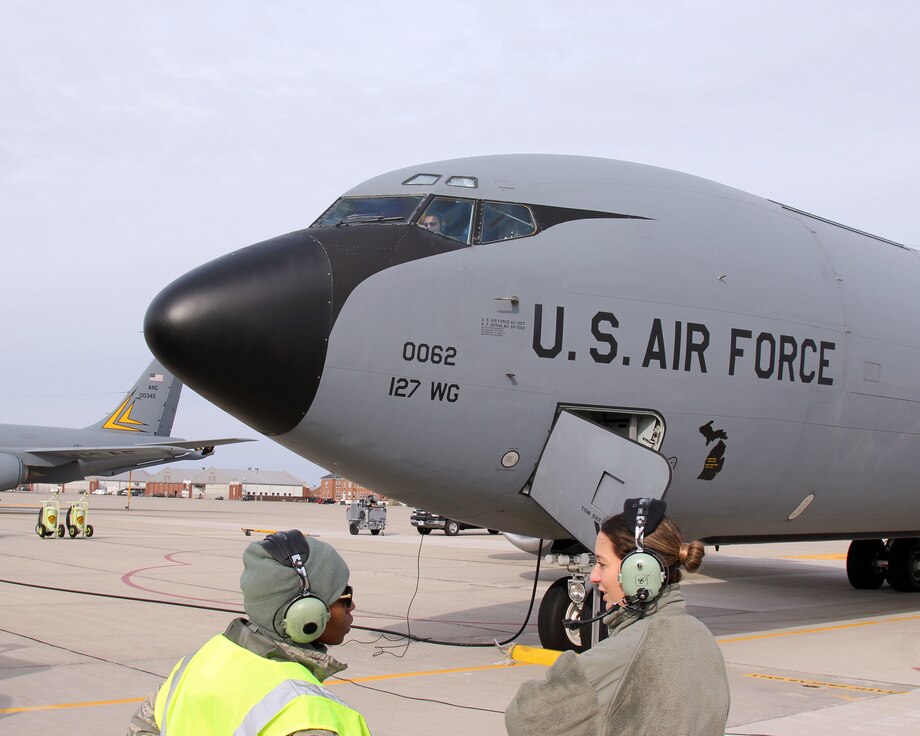 Senior Airmen Leslie Whitfield and Nikki Anderson prepare to launach a KC-135 Stratotanker at Selfridge Air National Guard Base, Mich., Nov. 4, 2018. Lt. Col. Leah Voelker, the aircraft commander for this flight, can be seen sitting at the pilot's controls inside the aircraft.