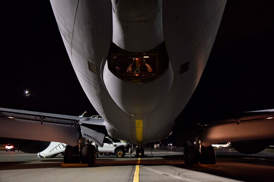 Master Sgt. Matt Huff, a boom operator with the 171st Air Refueling Squadron, Michigan Air National Guard, performs a preflight check in the boom pod of a KC-135 Stratotanker prior to an early evening take-off at Joint Base Pearl Harbor Hickam, Hawaii, Nov, 9, 2018.