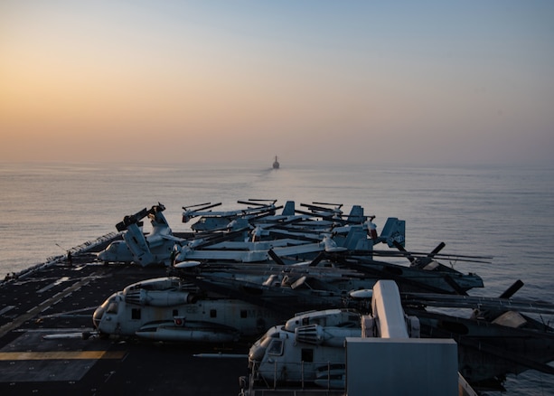 STRAIT OF HORMUZ (Oct. 10, 2018) Arleigh Burke-class guided-missile destroyer USS The Sullivans (DDG 68) transits the Strait of Hormuz in formation with Wasp-class amphibious assault ship USS Essex (LHD 2) during a regularly scheduled deployment of Essex Amphibious Ready Group and 13th Marine Expeditionary Unit. USS Essex is a lethal, flexible, and persistent Navy-Marine Corps team deployed to the U.S. 5th Fleet area of operation in support of naval operations to ensure maritime stability and security in the Central Region, connecting the Mediterranean and the Pacific through the western Indian Ocean and three strategic choke points. (U.S. Navy photo by Mass Communication Specialist 3rd Class Jenna Dobson/Released)