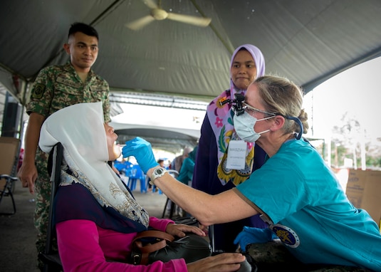 Lt. Inga O'Shea conducts a dental exam in Malaysia during Pacific Partnership 2018.