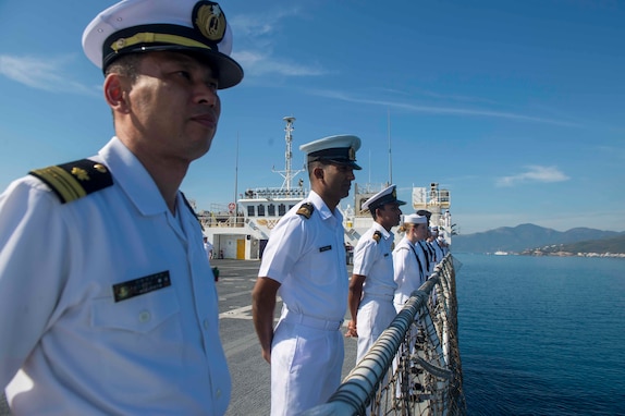 Joint service members man the rails aboard USNS Mercy as the ship arrives in Vietnam for Pacific Partnership 2018.
