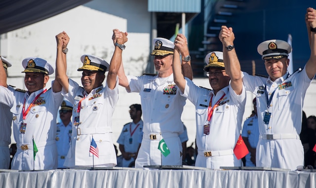 Rear Adm. Don Gabrielson celebrates with partner nation service members at the opening ceremony of Exercise Komodo.