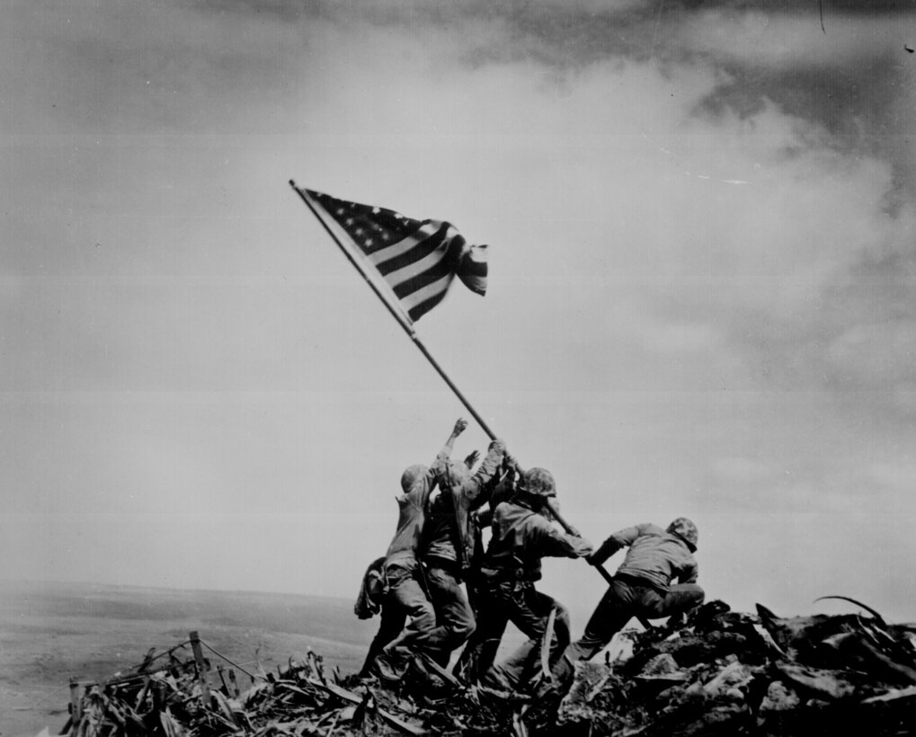Five Marines and a Navy corpsman raise the flag of the United States, during the Battle of Iwo Jima on Feb. 23, 1945. The picture was widely reproduced and came to be regarded in the United States as one of the most significant and recognizable images of the war. “The photograph depicts the potential of victory about to be fulfilled,” said Daniel Kariko, an assistant professor of photography at East Carolina University. “The flag is taking air and is about to unfurl, and the pole is about to become vertical, symbolizing triumph.”