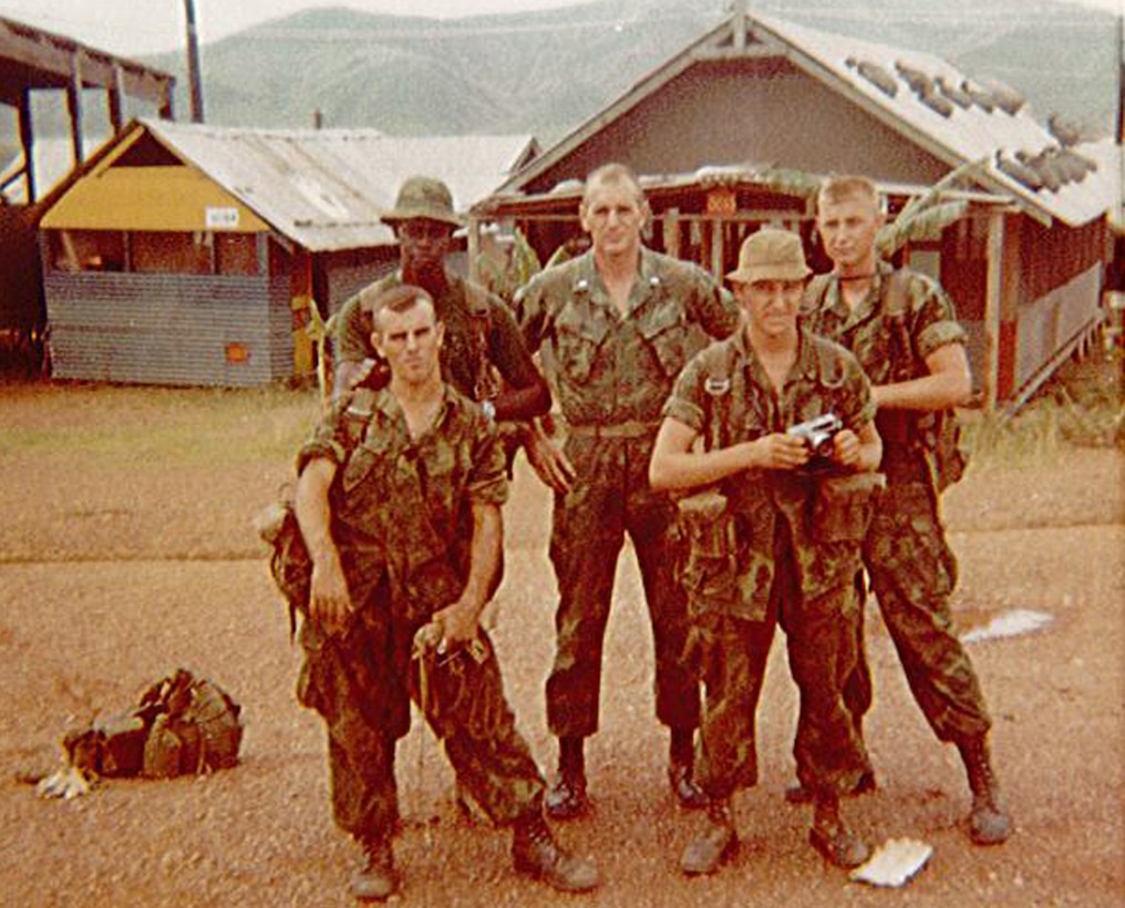 Charles Lynn Lowder, middle, and a group of his Marines stop for a photo while on duty in Vietnam.