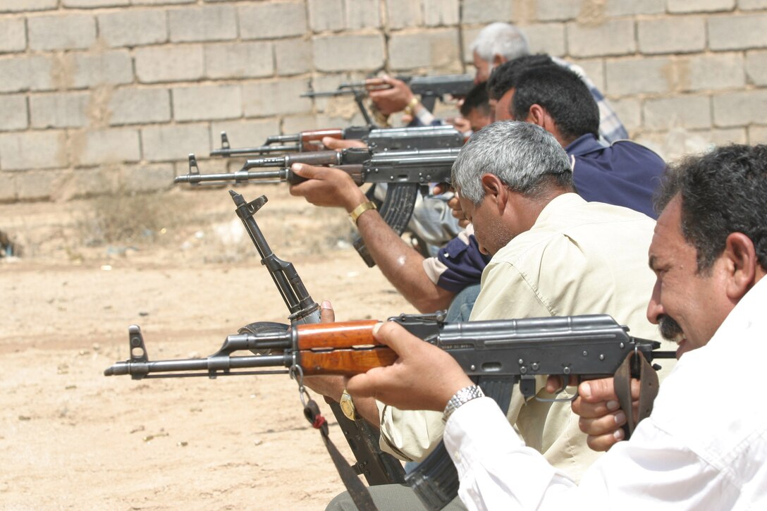 AR RAMADI, Iraq - Glass factory security guards fire AK-47 rifles during a familiarization fire instructed by the 2nd Marine Division's Marksmanship Training Unit, April 27.  U.S. Marine Corps photo by Sgt. Stephen D'Alessio (RELEASED)