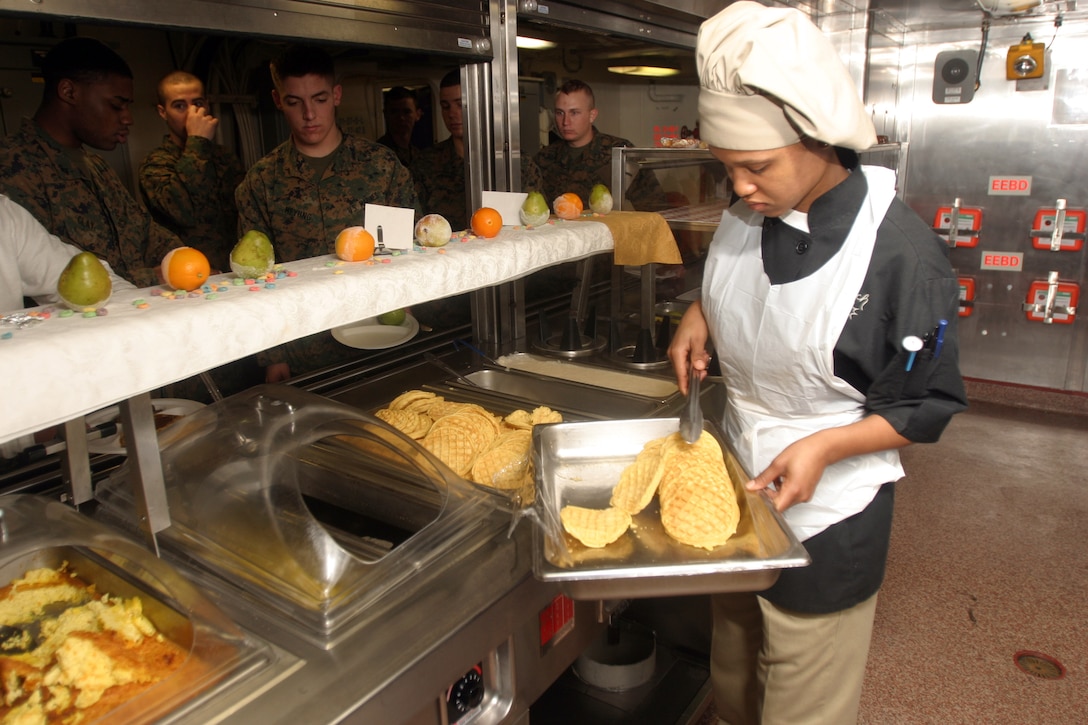 OFF THE COAST OF NORTH CAROLINA (March 11, 2008) -- Petty Officer 2nd Class Keisha Benjamin serves breakfast aboard USS San Antonio for the crew and nearly 600 embarked Marines.  An additional 1800 meals a day keep the messmen and augmented Marines busy in the galley.  Battalion Landing Team 3/8 and Marines from the 26th Marine Expeditionary Unit are aboard the San Antonio to conduct exercises during the ships Operational Evaluation, which will measure the new ship's ability to support Marine expeditionary operations.  (Official USMC photo by LCpl Jacob Chase) (Released)