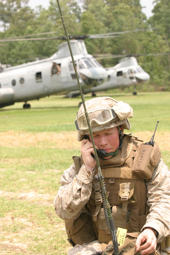 Lance Cpl. Lane K. Masters, a radio operator with Battalion Landing Team 2/6, 26th Marine Expeditionary Unit, communicates with other BLT Marines shortly after arriving via CH-46E Sea Knight helicopter at a mock Non-Combatant Evacuation exercise. Marines and sailors conducted the exercise during Composite Training Unit Exercise on Camp Lejeune, North Carolina, July 23, 2008. The exercise is part of the certification process the MEU must complete for the final exercise of its predeployment training period.  (Official USMC photo by Staff Sgt. Bryce Piper)