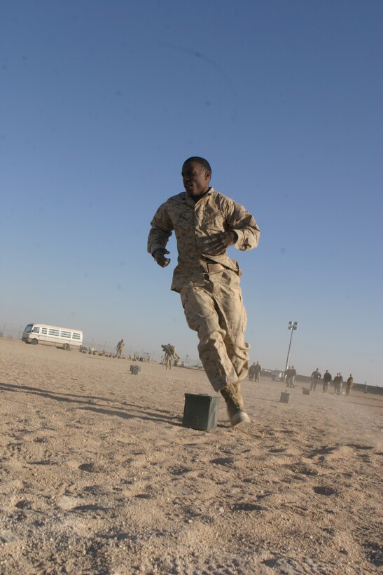 Sergeant Michael D. Harris from the 26th Marine Expeditionary Unit Command Element zigzags around ammo cans as part of the maneuver under fire portion of the Combat Fitness Test conducted during sustainment training at Camp Buehring, Kuwait, Jan. 03, 2009. The 26th MEU is currently deployed to the U.S. Central Command Area of Operation as part of its 2008-2009 deployment. (Official USMC photo by Lance Cpl. Jacob W. Chase) (Released)::r::::n::