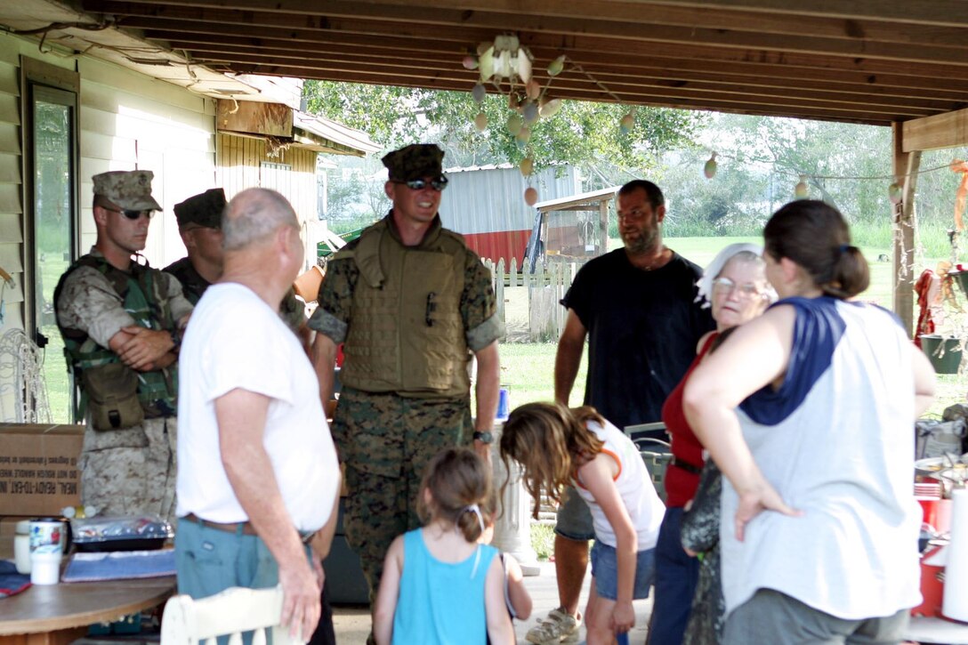 The Marines of the 4th Anti-Terrorism Battalion voluntarily mobilized from their reserve headquarters in Bessemer, Al. have just gave a family food and water, because its not possible to get by the floodwaters of Hurricane Rita in New Iberia La. and surrounding areas on September 25, 2005. The Marines also have delivered food and water to people that been stranded by the floodwaters. (United States Marine Corps Photo By Pfc Christopher D. Nette)