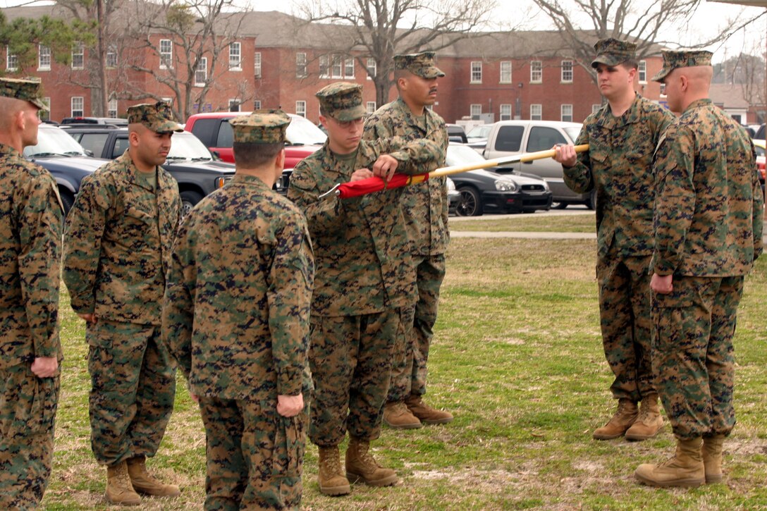Marine Corps Base Camp Lejeune, N.C. (March 10, 2006)--Marines with Foreign Military Training Unit unfurl thier guidon during part of an small informal ceremony for the activation of Company "A". The company is the first active in FMTU and the unit itself is the first active in their parent command, Marine Forces Special Operations Command . (Official U. S. Marine Corps photo by Cpl. Ken Melton)