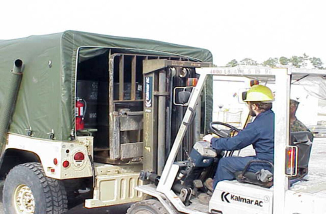 MARINE CORPS BASE CAMP LEJEUNE, N.C. - A worker recently unloads a small shipment of waste materials at the Hazardous Material Control Center in building 977. The HMCC, located on Michael Street, reissues serviceable hazardous materials back to various units instead of being disposed of as hazardous waste. (photo courtesty os the Hazardous Material Control Center)