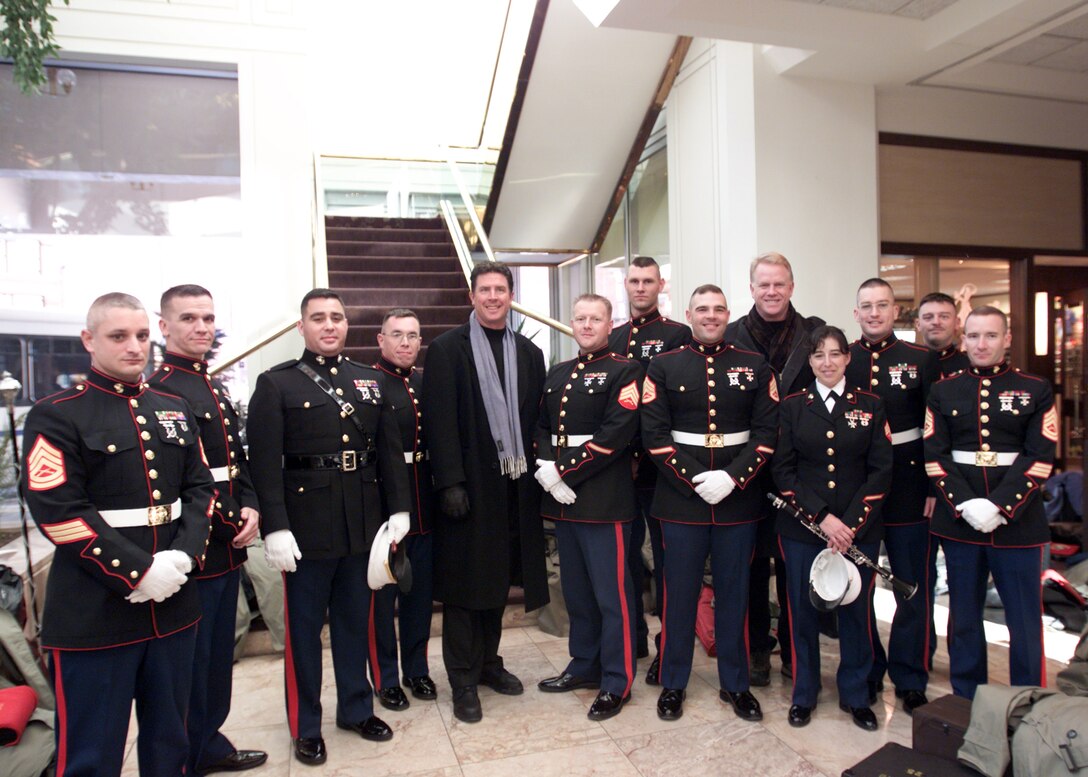 Legendary NFL quarterbacks Dan Marino and Boomer Esiason took time to greet the Marines from the Parris Island Marine Band in the lobby of the Westin Hotel in Pittsburgh, Sunday. Marino and Esiason were part of the CBS NFL Today broadcasting team that covered the AFC Championship game between the Pittsburgh Steelers and the New England Patriots. The Marines from Marine Corps Recruit Depot Parris Island, S.C., performed during the championship game's pre-game and half time shows at Heinz Field. The Patriots beat the Steelers 41-27 and advance to the Super Bowl on Feb. 6. The game was also televised live to Marines in Fallujah, Iraq.