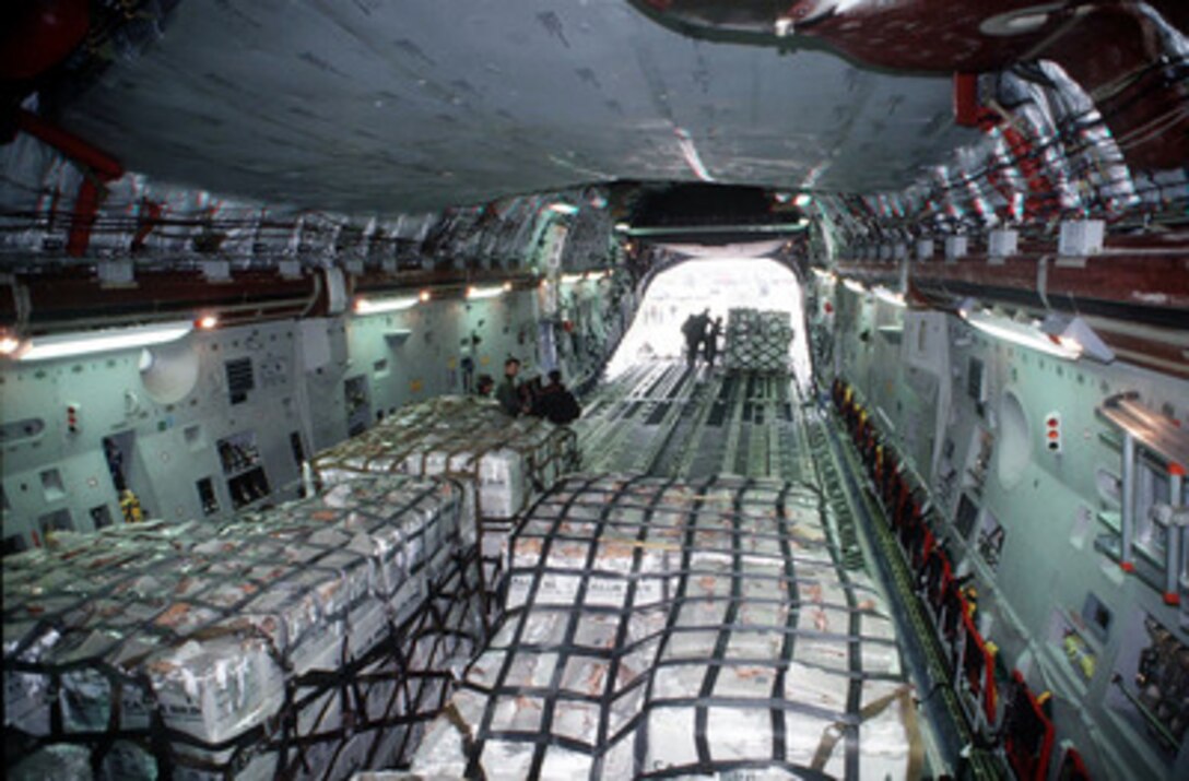 U.S. Air Force ground crew members push pallets of kerosene and wood chips into a C-17 Globemaster III aircraft at the Ancona, Italy, airport on Dec. 7, 1995. The humanitarian cargo is being flown into Sarajevo as part of Operation Provide Promise. The ground crew is deployed from the 62th Aerial Port Squadron Mobility Flight, McChord Air Force Base, Wash. The Globemaster III belongs to the 437th Air Lift Wing, Charleston Air Force Base, S.C. 