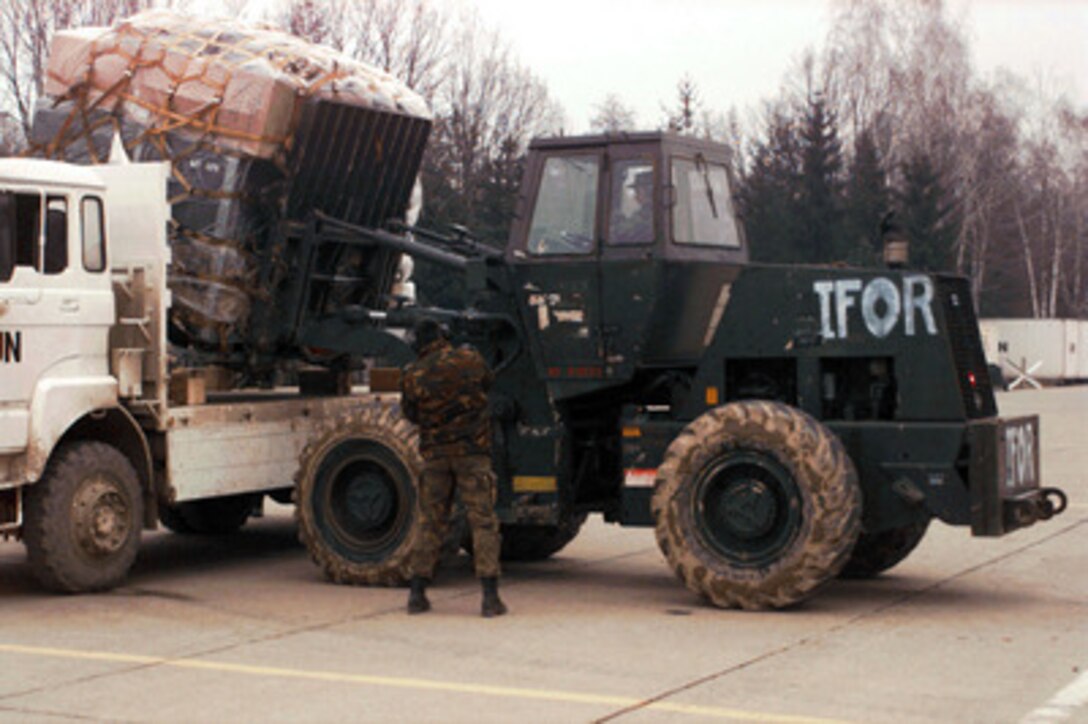Staff Sgt. James Rustin, U.S. Air Force, places a pallet of supplies on a truck on the runway of the airport at Tuzla, Bosnia and Herzegovina, on Dec. 11, 1995. Rustin, an air transportation specialist from the 621st Aerial Port Squadron, McGuire Air Force Base, N.J., is attached to the 4100 Group Provisional, Tanker Airlift Control Element. The airmen, as part of the NATO Enabling Force of Operation Joint Endeavor, are setting up operations to bring airfield up to a 24 hour capability. Enabling forces are moving into the Croatia, Bosnia and Herzegovina, and Slovenia theaters of operation to prepare entry points for the main Implementation Force. 