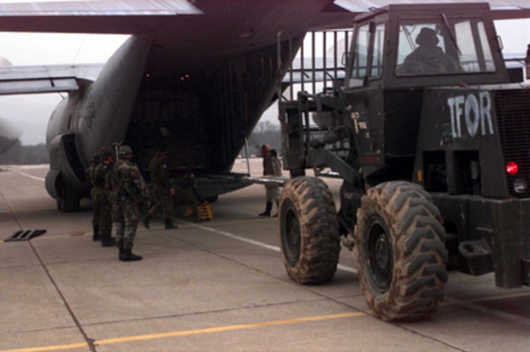 Staff Sgt. James Rustin, U.S. Air Force, prepares to remove a pallet of supplies from a C-130 with his forklift on the runway of the airport at Tuzla, Bosnia and Herzegovina, on Dec. 11, 1995. Rustin, an air transportation specialist from the 621st Aerial Port Squadron, McGuire Air Force Base, N.J., is attached to the 4100 Group Provisional, Tanker Airlift Control Element. The airmen, as part of the NATO Enabling Force of Operation Joint Endeavor, are setting up operations to bring airfield up to a 24 hour capability. Enabling forces are moving into the Croatia, Bosnia and Herzegovina, and Slovenia theaters of operation to prepare entry points for the main Implementation Force. 