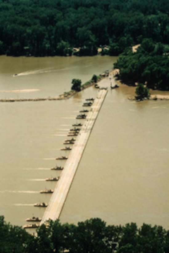 U.S. Army combat engineers use bridge erection boats to place a ribbon float bridge across the Arkansas River during field training near Fort Chaffee, Ark., in July. Ribbon bridges like this will be used by the Army's 1st Armored Division to cross the Sava River between Croatia and Bosnia and Herzegovina. The engineers are part of the NATO Enabling Force of Operation Joint Endeavor. Enabling forces are moving into the Croatia, Bosnia and Herzegovina, and Slovenia theaters of operation to prepare entry points for the main Implementation Force. 