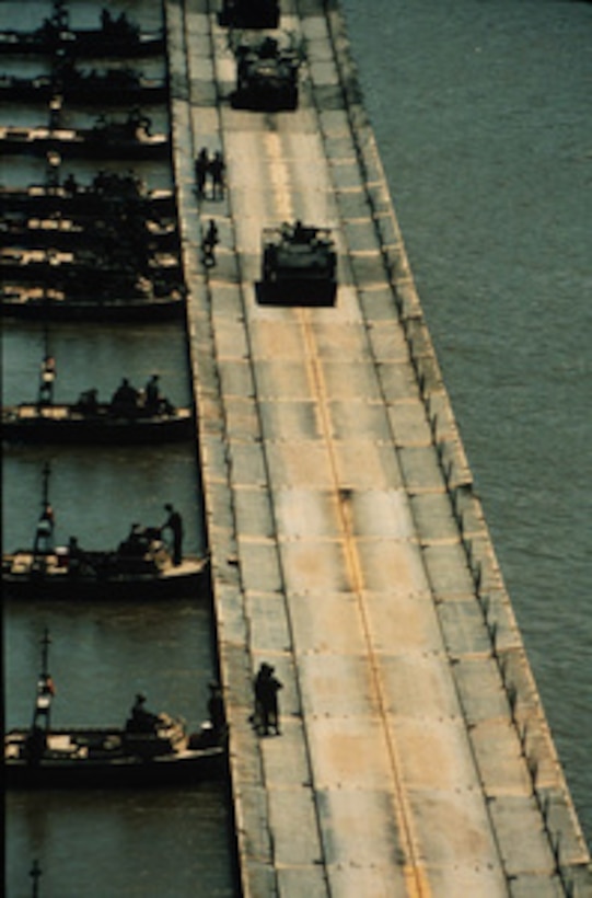 U.S. Army combat vehicles cross a ribbon float bridge across the Arkansas River during field training near Fort Chaffee, Ark., in July. Ribbon bridges like this will be used by the Army's 1st Armored Division to cross the Sava River between Croatia and Bosnia and Herzegovina. The engineers are part of the NATO Enabling Force of Operation Joint Endeavor. Enabling forces are moving into the Croatia, Bosnia and Herzegovina, and Slovenia theaters of operation to prepare entry points for the main Implementation Force. 