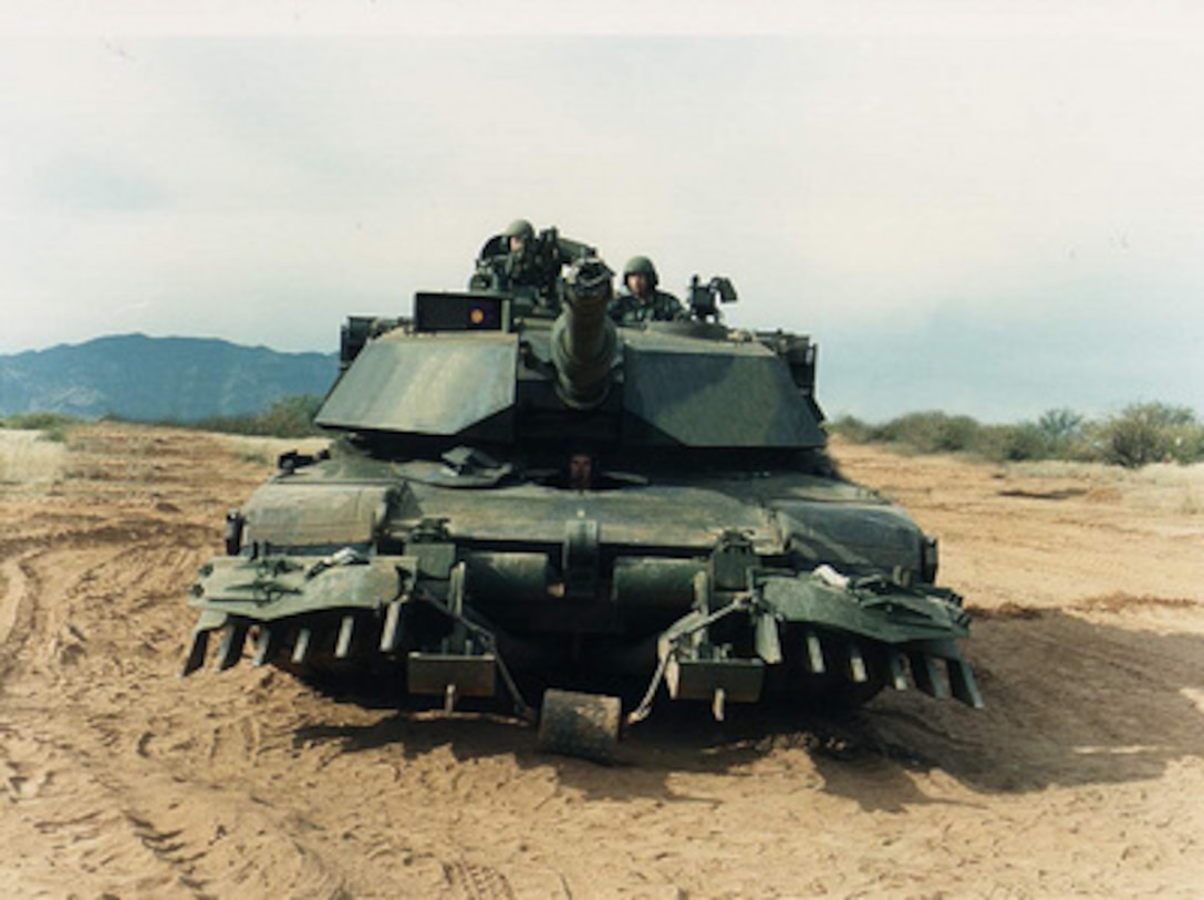 A U.S. Army M-1A1 Abrams main battle tank is equipped with a mine plow which is designed to push mines out of the tank's path, clearing a lane for other vehicles to follow. The Army's 1st Armored Division will deploy mine plows such as these to Bosnia and Herzegovina for NATO's Operation Joint Endeavor. 