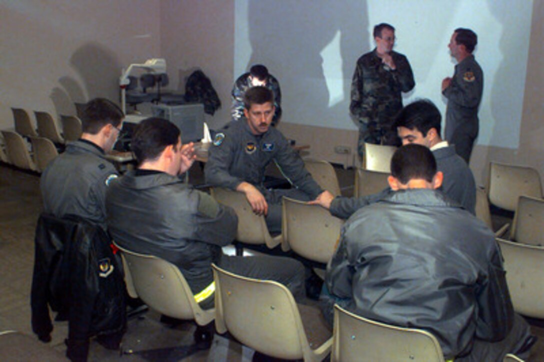 U.S. Air Force C-130 Hercules Pilot Capt. Don Kudym (center) conducts a pre-flight, mission briefing with his crew at Ramstein Air Base, Germany, on Dec. 18, 1995. The mission will involve flying to Brindisi Italian Air Station, Italy, and loading two Humvee's that will be flown to Sarajevo, Bosnia and Herzegovina, to support the NATO Enabling Force of Operation Joint Endeavor. Enabling forces are moving into the Croatia, Bosnia and Herzegovina, and Slovenia theaters of operation to prepare entry points for the main Implementation Force. Kudym and his crew are attached to the 37th Airlift Squadron at Ramstein Air Base, Germany. 